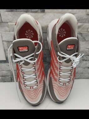 Men's Nike athletic shoes in a white, red, and gray color combination—practical